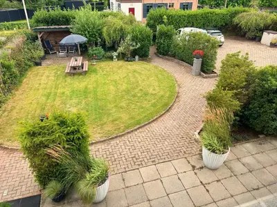 an aerial view of a garden with a table and benches at Villa Grenszicht in Nispen