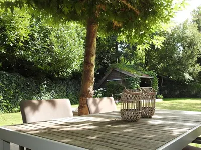 a wooden table with two vases on top of it at Casa Milo in Lokeren