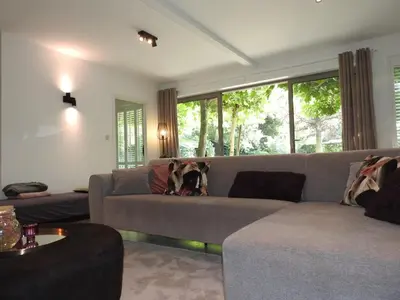 a living room with a couch with a dog on it at Casa Milo in Lokeren