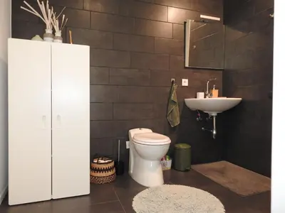 a bathroom with a toilet and a sink at Casa Milo in Lokeren