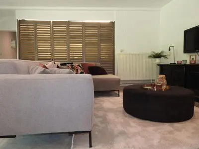 a living room with a couch and a table at Casa Milo in Lokeren