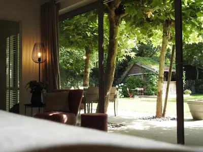 a room with a table and chairs and a window at Casa Milo in Lokeren