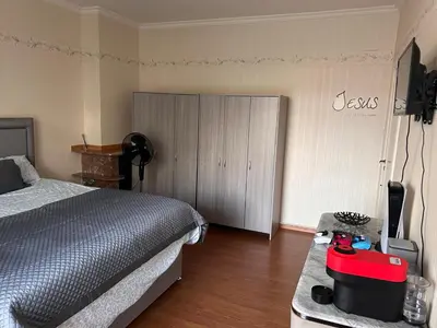 a bedroom with a bed and a dresser and a television at Dream home for tomorrow land in Boom