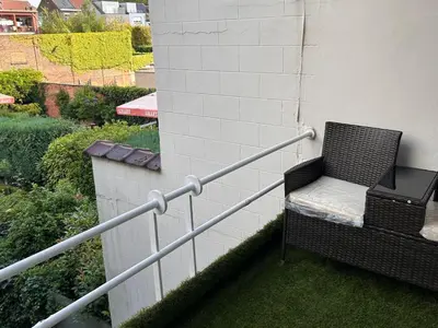 a wicker chair sitting on the side of a building at Dream home for tomorrow land in Boom
