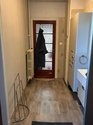 a hallway with a door with a robe on it at Dream home for tomorrow land in Boom