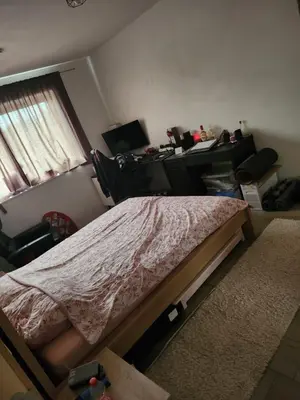 a bedroom with a bed and a desk with a computer at Tomorrowland rooms in Rumst