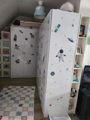 a room with a white refrigerator with stickers on it at Tomorrowland rooms in Rumst