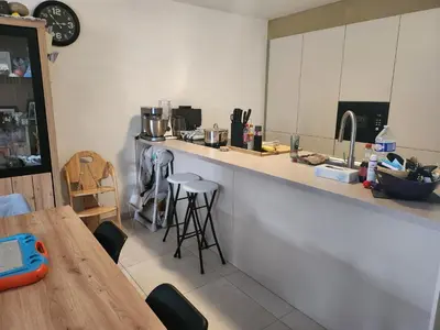 a kitchen with a counter and a table and chairs at Tomorrowland rooms in Rumst