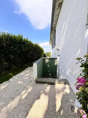 a building with a green door on the side of it at Studio with sauna in Meise