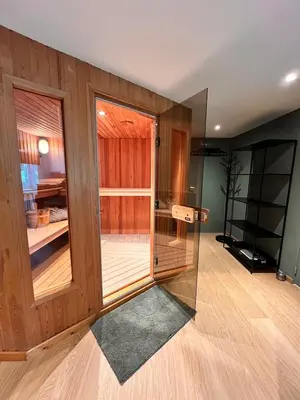 a room with a glass door in a room at Studio with sauna in Meise