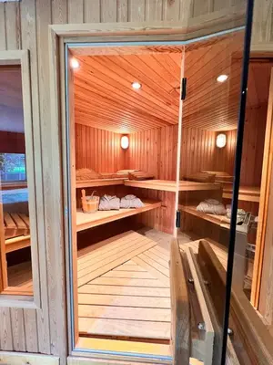 a sauna with wooden walls and wooden shelves at Studio with sauna in Meise