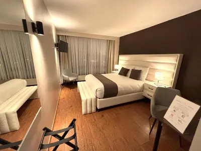 a hotel room with a bed and a couch at Escale Hotel in Brussels
