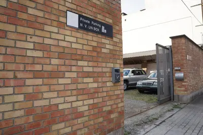 a brick wall with a sign on the side of a building at Escale Hotel in Brussels