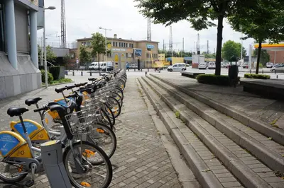 a row of bikes parked next to a street at Escale Hotel in Brussels