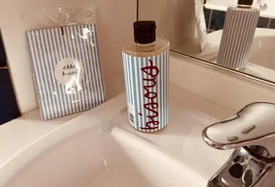 a bottle of toothpaste sitting on top of a bathroom sink at Charmante woning in de Vlaamse Ardennen in Sint-Lievens-Houtem