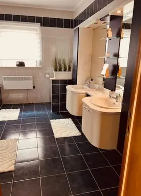 a bathroom with a sink and a toilet and a mirror at Charmante woning in de Vlaamse Ardennen in Sint-Lievens-Houtem