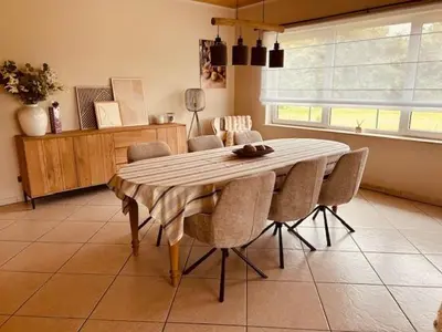 a dining room table and chairs in a room at Charmante woning in de Vlaamse Ardennen in Sint-Lievens-Houtem