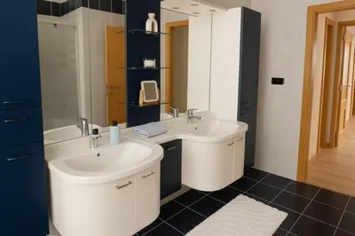 a bathroom with two sinks and a large mirror at Charmante woning in de Vlaamse Ardennen in Sint-Lievens-Houtem