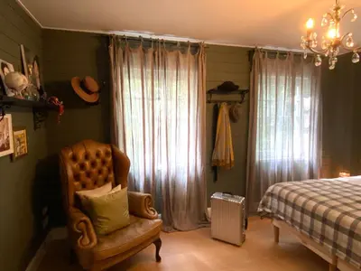 a bedroom with a chair and a bed at A Calm & Quiet Stay in Wuustwezel