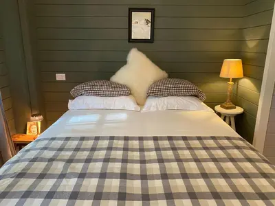 a bedroom with a bed with a checkered blanket at A Calm & Quiet Stay in Wuustwezel