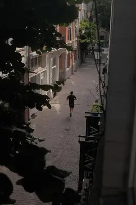 a man is walking down a street at Studio Nolo by Simone Antwerp in Antwerp