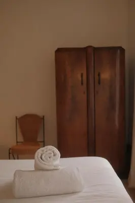 a stack of towels sitting on top of a bed at Studio Nolo by Simone Antwerp in Antwerp