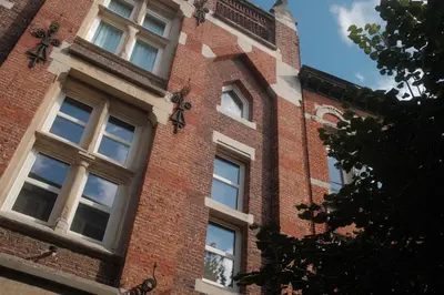 a brick building with windows on the side of it at Studio Nolo by Simone Antwerp in Antwerp