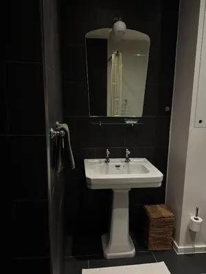 a bathroom with a sink and a mirror at Studio Nolo by Simone Antwerp in Antwerp