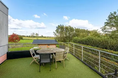 a patio with a table and chairs on a balcony at Klavertje Lier Pallieter in Lier