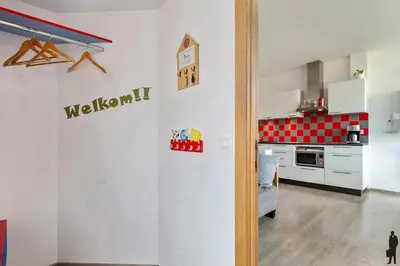 a kitchen with white cabinets and a red checkered counter top at Klavertje Lier Pallieter in Lier