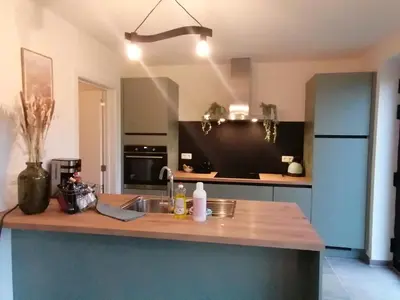 a kitchen with a counter with a sink and a refrigerator at Sandrise in Balen