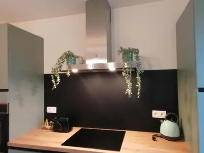 a kitchen with a black and white wall at Sandrise in Balen