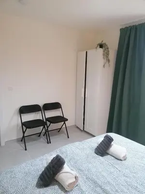 a room with two chairs and a bed with towels at Sandrise in Balen