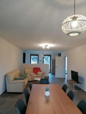 a living room with a table and a couch at Sandrise in Balen