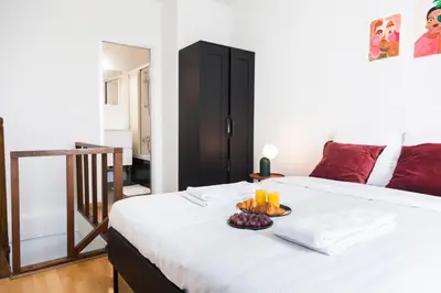 a bedroom with a bed with a tray of fruit on it at Brussels St Gilles Elegant residence in Brussels