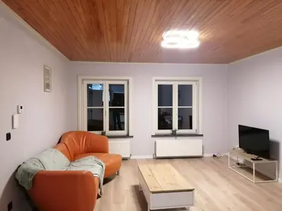 a living room with a couch and a table at Rent and Relax Geel in Geel
