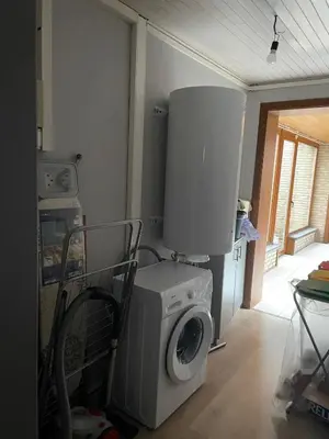 a laundry room with a washing machine and a washer at Rent and Relax Geel in Geel