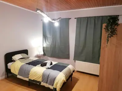 a bedroom with a bed with a dog on it at Rent and Relax Geel in Geel