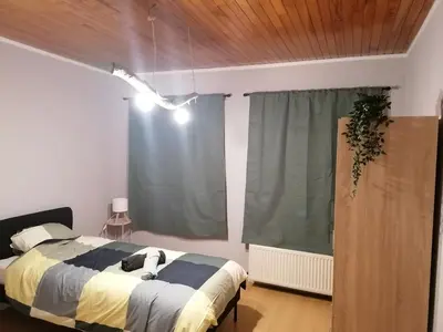 a bedroom with a bed and a window at Rent and Relax Geel in Geel