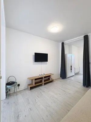 a living room with a flat screen tv on the wall at Spacieux appartement une chambre in Brussels