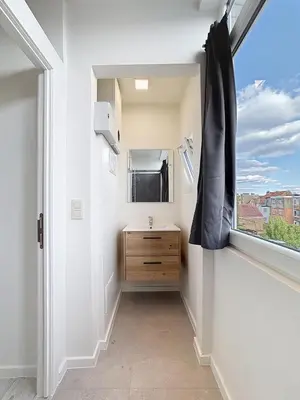 a bathroom with a sink and a window at Spacieux appartement une chambre in Brussels