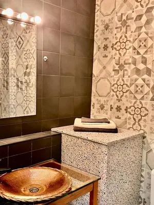 a bathroom with a sink and a mirror at Happy Home in Brussels