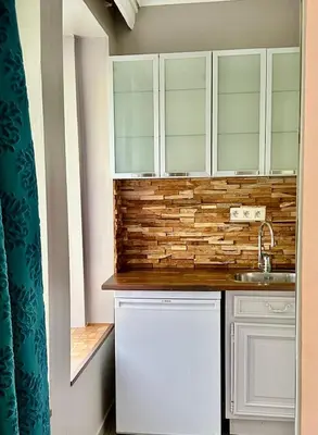 a kitchen with white cabinets and a sink at Happy Home in Brussels