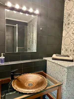 a bathroom with a sink and a mirror at Happy Home in Brussels