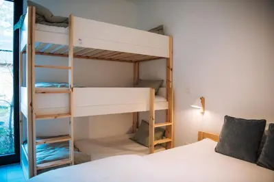 a bedroom with bunk beds and a bed at Knuscabin in Lille