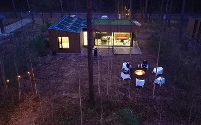 a group of people sitting at a table in a tiny house at Knuscabin in Lille