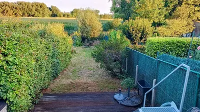 an overhead view of a garden with a wooden deck at Rustig gelegen woning in Tielrode in Temse