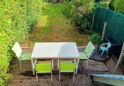 a white table and chairs on a deck at Rustig gelegen woning in Tielrode in Temse