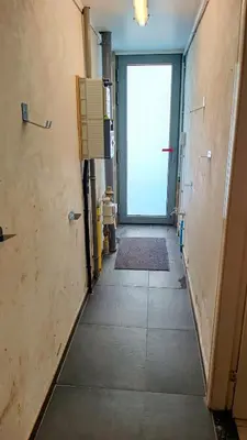 a hallway of an office building with a door at Rustig gelegen woning in Tielrode in Temse