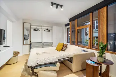 a bedroom with a bed and a window at Gezellig & Centraal - 4 Persoons Gentse Studio in Ghent